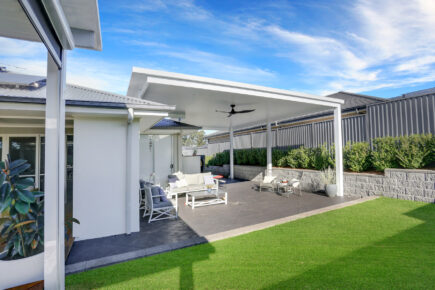 Modern backyard patio with seating and lawn