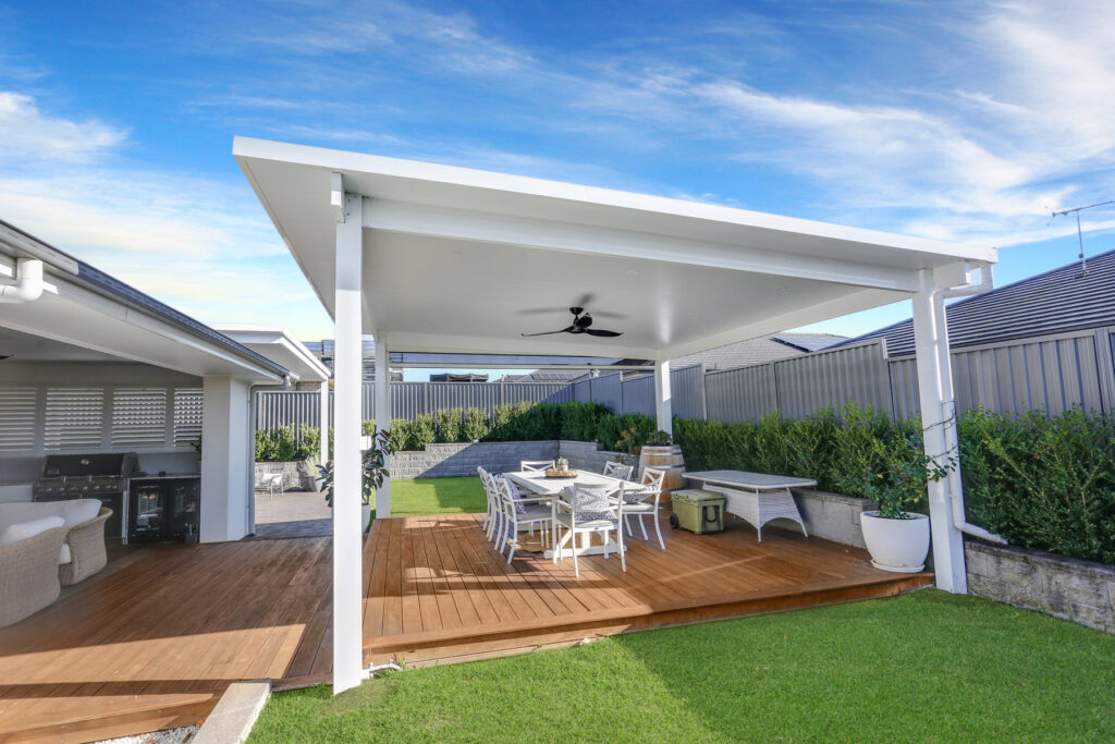 Modern outdoor patio with dining area and fan.