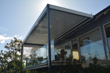 Modern house with glass railing and awnings