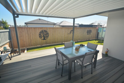 Opening Roof patio with outdoor furniture and wooden fence.