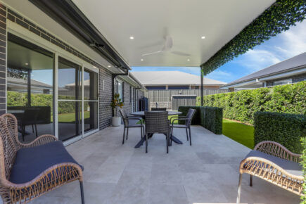 Modern outdoor patio with table and chairs.