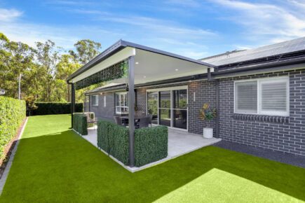 Modern patio with solar panels and artificial grass