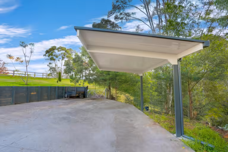 Modern carport with scenic rural backdrop