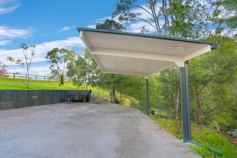 Modern carport with scenic rural backdrop