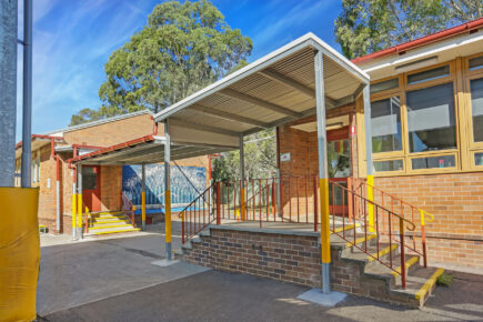 Primary school entrance with stairs and ramp.