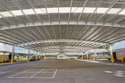 Covered school cola with metal roof structure.