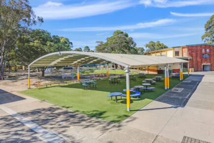 School outdoor seating area under a school cola