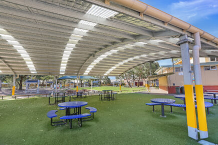 Covered outdoor seating in school cola playground