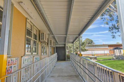 Wheelchair accessible school cola under metal roof.