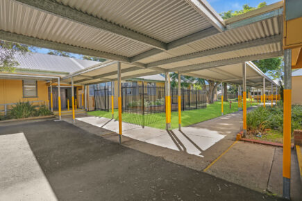 Covered walkway in Australian school courtyard.