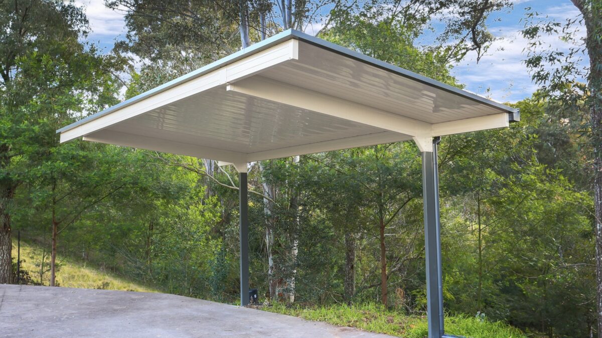 Modern outdoor shelter amidst lush green trees.