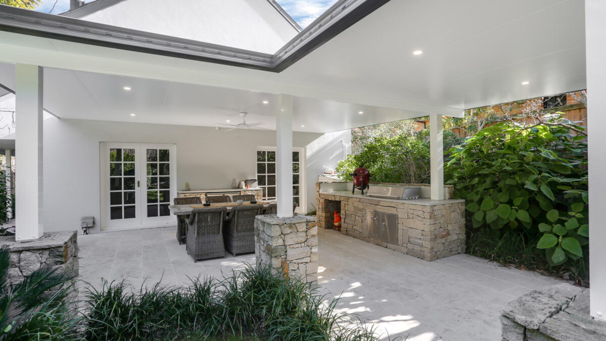 Modern outdoor patio with dining area and garden view.