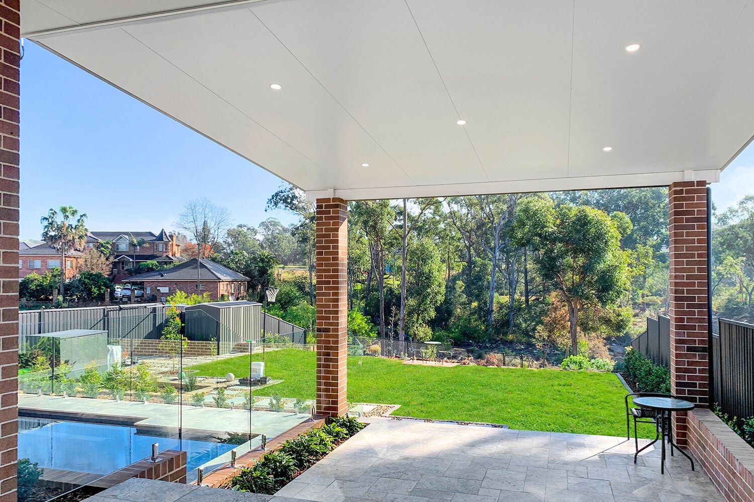 Backyard view with pool and garden from patio